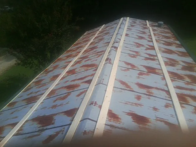 Rusted metal roof panels with new wood purlins before replacement — Storm Damage Roof Repair in Boyce by Roofing Brothers